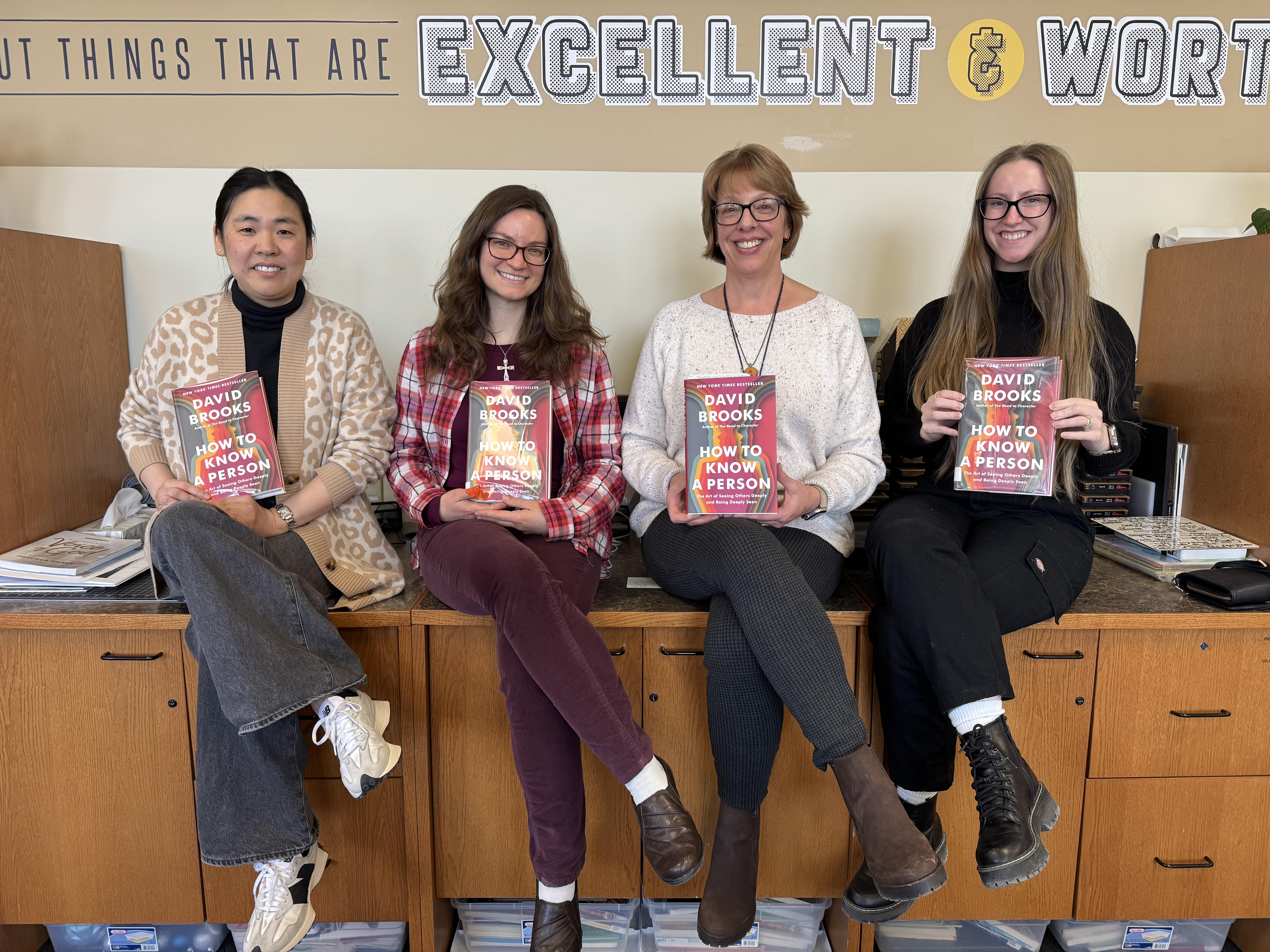 Photo of the Valor Library team holding a copy of "How to Know a Person: The Art of Seeing Others Deeply and Being Deeply Seen" by David Brooks